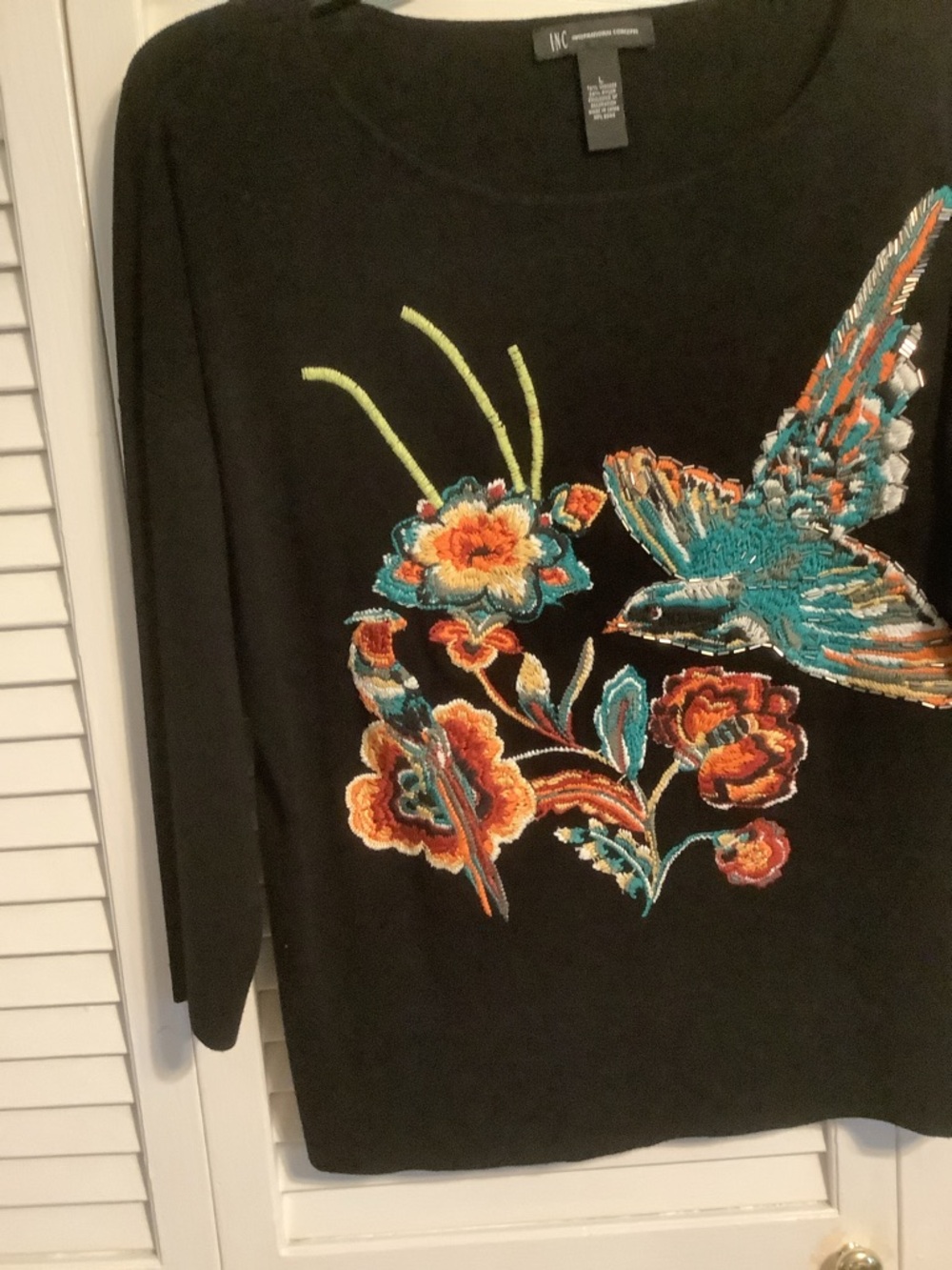 INC  Black Sweater with Teal and Orange Embroidered design.
